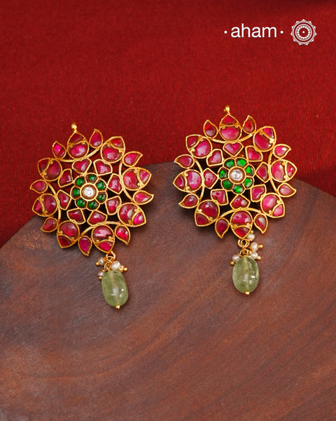 Expertly crafted with intricate kundan work, these Kundan Gold Polish Silver Earrings exude elegance and radiate sophistication. Made of 92.5 silver with a lustrous gold polish, they feature a timeless red and green color combination that pairs great with with most traditional Indian clothes. Elevate any outfit and make a statement with these exquisite earrings.