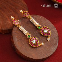 These Gold Polish Paisley Silver Earrings beautifully reflect the elegance of South Indian traditional design, featuring delicate kemp and pearl work. Crafted from 92.5% pure silver with a fine gold polish, it is a graceful and timeless design that complements your style effortlessly.