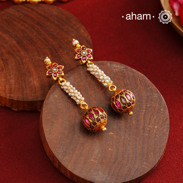 These Gold Polish Silver Earrings beautifully reflect the elegance of South Indian traditional design, featuring delicate kemp and pearl work. Crafted from 92.5% pure silver with a fine gold polish, it is a graceful and timeless design that complements your style effortlessly.
