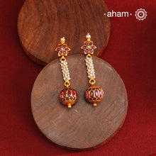 These Gold Polish Silver Earrings beautifully reflect the elegance of South Indian traditional design, featuring delicate kemp and pearl work. Crafted from 92.5% pure silver with a fine gold polish, it is a graceful and timeless design that complements your style effortlessly.