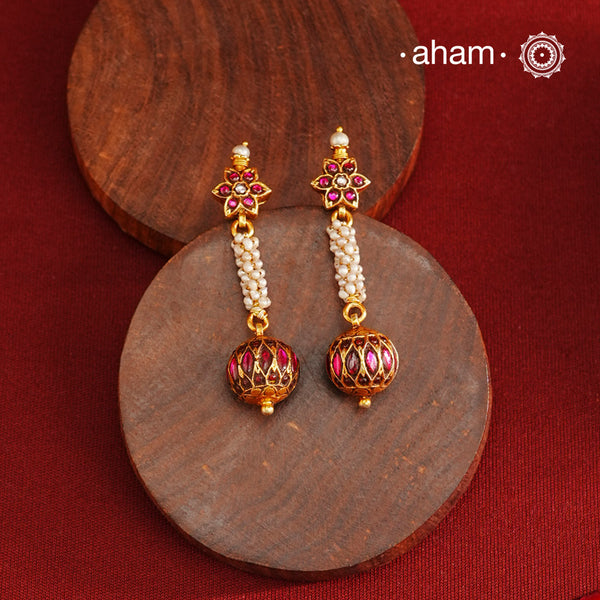 These Gold Polish Silver Earrings beautifully reflect the elegance of South Indian traditional design, featuring delicate kemp and pearl work. Crafted from 92.5% pure silver with a fine gold polish, it is a graceful and timeless design that complements your style effortlessly.