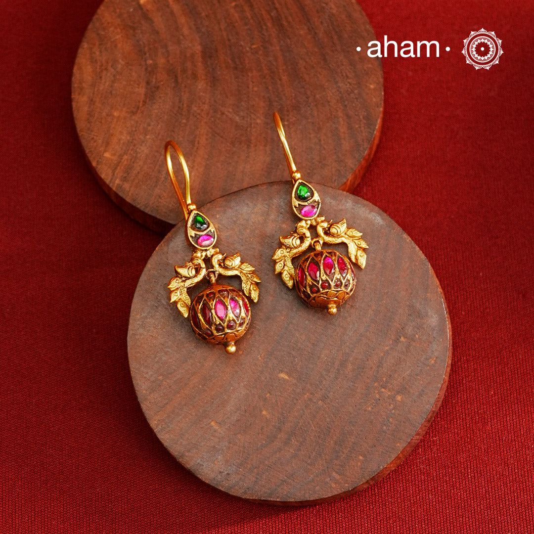 These Gold Polish Peacock Silver Earrings beautifully reflect the elegance of South Indian traditional design, featuring delicate kemp work. Crafted from 92.5% pure silver with a fine gold polish, it is a graceful and timeless design that complements your style effortlessly.