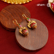 These Gold Polish Peacock Silver Earrings beautifully reflect the elegance of South Indian traditional design, featuring delicate kemp work. Crafted from 92.5% pure silver with a fine gold polish, it is a graceful and timeless design that complements your style effortlessly.