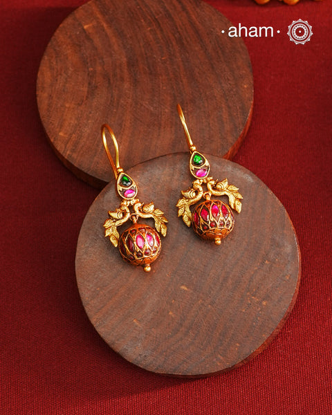 These Gold Polish Peacock Silver Earrings beautifully reflect the elegance of South Indian traditional design, featuring delicate kemp work. Crafted from 92.5% pure silver with a fine gold polish, it is a graceful and timeless design that complements your style effortlessly.