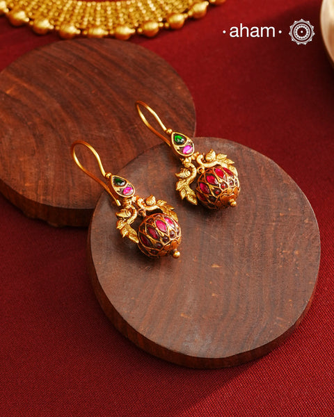 These Gold Polish Peacock Silver Earrings beautifully reflect the elegance of South Indian traditional design, featuring delicate kemp work. Crafted from 92.5% pure silver with a fine gold polish, it is a graceful and timeless design that complements your style effortlessly.