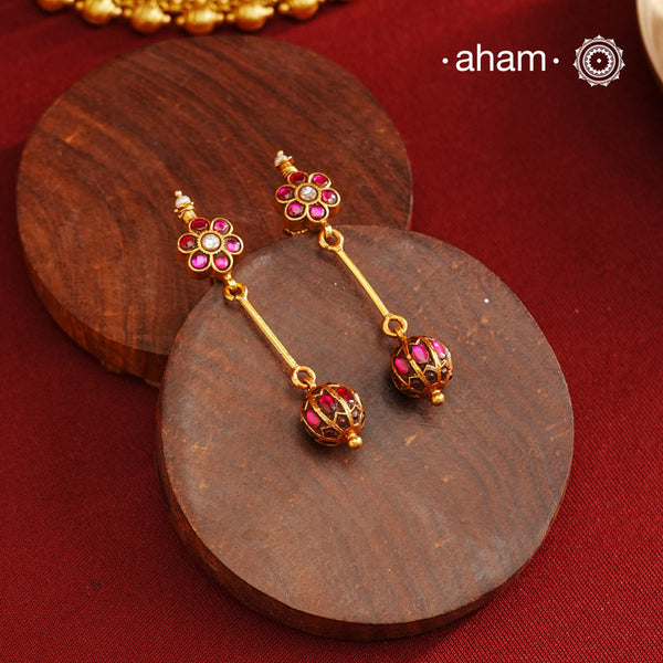 These Gold Polish Silver Earrings beautifully reflect the elegance of South Indian traditional design, featuring delicate kemp work. Crafted from 92.5% pure silver with a fine gold polish, it is a graceful and timeless design that complements your style effortlessly.