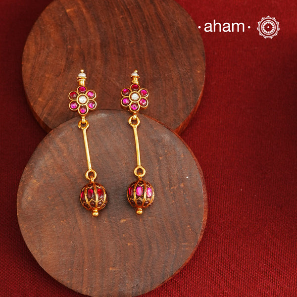 These Gold Polish Silver Earrings beautifully reflect the elegance of South Indian traditional design, featuring delicate kemp work. Crafted from 92.5% pure silver with a fine gold polish, it is a graceful and timeless design that complements your style effortlessly.