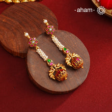These Gold Polish Peacock Silver Earrings beautifully reflect the elegance of South Indian traditional design, featuring delicate kemp and pearl work. Crafted from 92.5% pure silver with a fine gold polish, it is a graceful and timeless design that complements your style effortlessly.