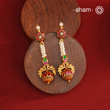 These Gold Polish Peacock Silver Earrings beautifully reflect the elegance of South Indian traditional design, featuring delicate kemp and pearl work. Crafted from 92.5% pure silver with a fine gold polish, it is a graceful and timeless design that complements your style effortlessly.