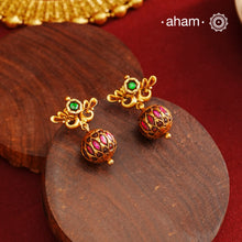 These Gold Polish Peacock Silver Earrings beautifully reflect the elegance of South Indian traditional design, featuring delicate kemp work. Crafted from 92.5% pure silver with a fine gold polish, it is a graceful and timeless design that complements your style effortlessly.