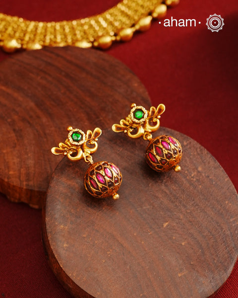 These Gold Polish Peacock Silver Earrings beautifully reflect the elegance of South Indian traditional design, featuring delicate kemp work. Crafted from 92.5% pure silver with a fine gold polish, it is a graceful and timeless design that complements your style effortlessly.