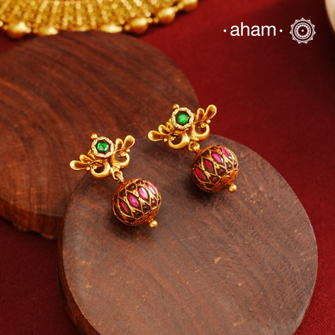 These Gold Polish Peacock Silver Earrings beautifully reflect the elegance of South Indian traditional design, featuring delicate kemp work. Crafted from 92.5% pure silver with a fine gold polish, it is a graceful and timeless design that complements your style effortlessly.