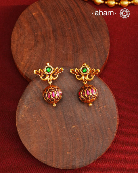 These Gold Polish Peacock Silver Earrings beautifully reflect the elegance of South Indian traditional design, featuring delicate kemp work. Crafted from 92.5% pure silver with a fine gold polish, it is a graceful and timeless design that complements your style effortlessly.