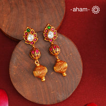 These Gold Polish Peacock Silver Earrings beautifully reflect the elegance of South Indian traditional design, featuring delicate kemp work. Crafted from 92.5% pure silver with a fine gold polish, it is a graceful and timeless design that complements your style effortlessly.