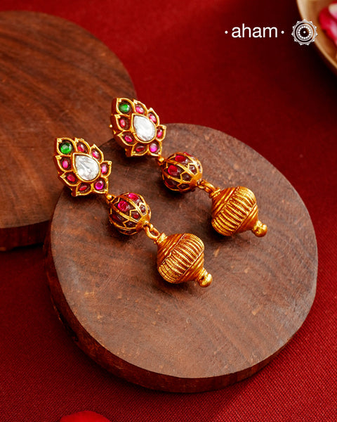 These Gold Polish Peacock Silver Earrings beautifully reflect the elegance of South Indian traditional design, featuring delicate kemp work. Crafted from 92.5% pure silver with a fine gold polish, it is a graceful and timeless design that complements your style effortlessly.