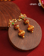 These Gold Polish Peacock Silver Earrings beautifully reflect the elegance of South Indian traditional design, featuring delicate kemp work. Crafted from 92.5% pure silver with a fine gold polish, it is a graceful and timeless design that complements your style effortlessly.