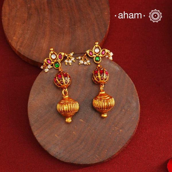 These Gold Polish Peacock Silver Earrings beautifully reflect the elegance of South Indian traditional design, featuring delicate kemp work. Crafted from 92.5% pure silver with a fine gold polish, it is a graceful and timeless design that complements your style effortlessly.