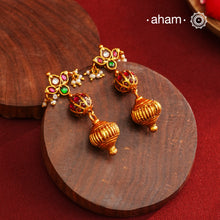 These Gold Polish Peacock Silver Earrings beautifully reflect the elegance of South Indian traditional design, featuring delicate kemp work. Crafted from 92.5% pure silver with a fine gold polish, it is a graceful and timeless design that complements your style effortlessly.