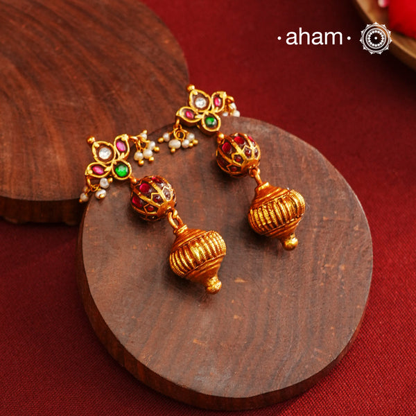 These Gold Polish Peacock Silver Earrings beautifully reflect the elegance of South Indian traditional design, featuring delicate kemp work. Crafted from 92.5% pure silver with a fine gold polish, it is a graceful and timeless design that complements your style effortlessly.