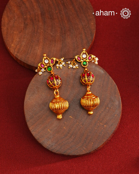 These Gold Polish Peacock Silver Earrings beautifully reflect the elegance of South Indian traditional design, featuring delicate kemp work. Crafted from 92.5% pure silver with a fine gold polish, it is a graceful and timeless design that complements your style effortlessly.