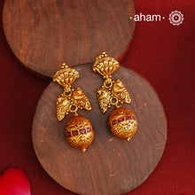 These Gold Polish Peacock Silver Earrings beautifully reflect the elegance of South Indian traditional design, featuring delicate kemp work. Crafted from 92.5% pure silver with a fine gold polish, it is a graceful and timeless design that complements your style effortlessly.