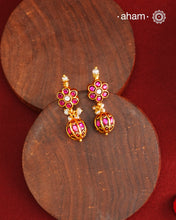 These elegant earrings feature intricate kemp work, meticulously crafted from 92.5% silver and enhanced with a subtle gold polish. Small pearls add delicate highlights, enhancing their traditional charm. Designed to complement a variety of traditional outfits, they blend classic artistry with versatile wearability.