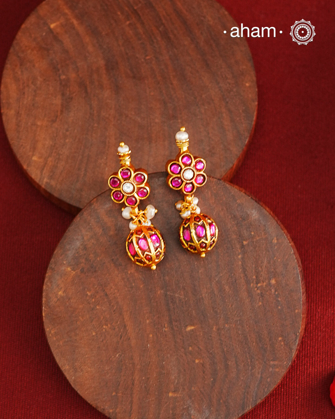 These elegant earrings feature intricate kemp work, meticulously crafted from 92.5% silver and enhanced with a subtle gold polish. Small pearls add delicate highlights, enhancing their traditional charm. Designed to complement a variety of traditional outfits, they blend classic artistry with versatile wearability.