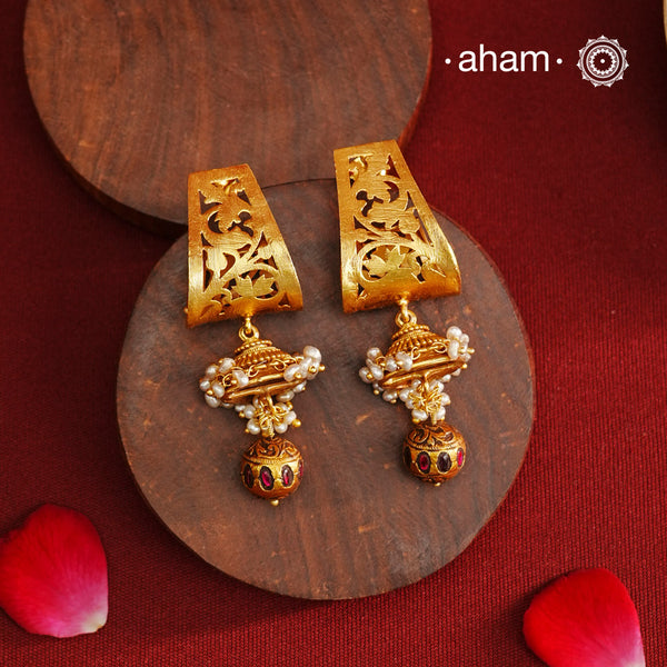 Gold Polish Silver Earrings that blend traditional South Indian artistry with a contemporary touch. Featuring intricate lattice work on the top and a striking kemp work drop, they are accented with subtle pearl highlight. Crafted from 92.5% pure silver and finished with a rich gold polish, these earrings offer both elegance and cultural heritage in a refined design.