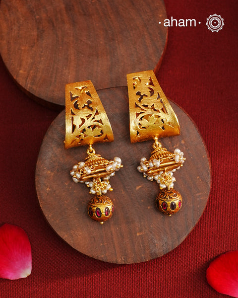 Gold Polish Silver Earrings that blend traditional South Indian artistry with a contemporary touch. Featuring intricate lattice work on the top and a striking kemp work drop, they are accented with subtle pearl highlight. Crafted from 92.5% pure silver and finished with a rich gold polish, these earrings offer both elegance and cultural heritage in a refined design.