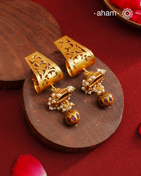 Gold Polish Silver Earrings that blend traditional South Indian artistry with a contemporary touch. Featuring intricate lattice work on the top and a striking kemp work drop, they are accented with subtle pearl highlight. Crafted from 92.5% pure silver and finished with a rich gold polish, these earrings offer both elegance and cultural heritage in a refined design.