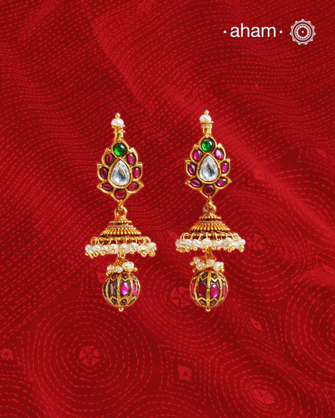 Statement gold polish silver jhumkie with kemp work. 
Handcrafted using traditional methods in 92.5 sterling silver with gold polish. 
Pair these with your ethnic outfits this festive season to ace your look.