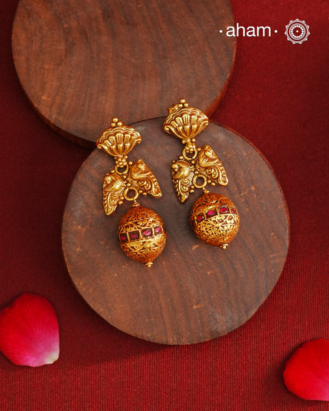 These Gold Polish Peacock Silver Earrings beautifully reflect the elegance of South Indian traditional design, featuring delicate kemp work. Crafted from 92.5% pure silver with a fine gold polish, it is a graceful and timeless design that complements your style effortlessly.