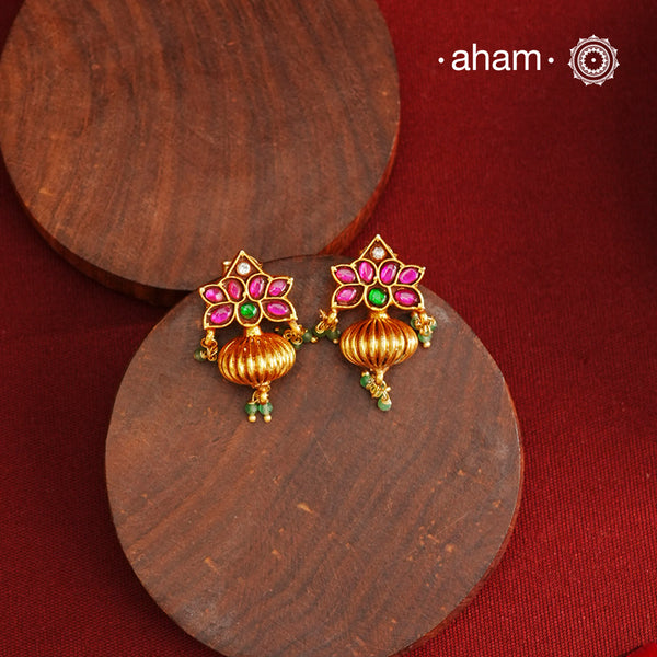 These Gold Polish Peacock Silver Earrings beautifully reflect the elegance of South Indian traditional design, featuring delicate kemp work. Crafted from 92.5% pure silver with a fine gold polish, it is a graceful and timeless design that complements your style effortlessly.