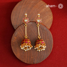 Jhumkie earring showcasing exquisite Kemp work, meticulously crafted in 92.5% silver with a fine gold polish finish. Adorned with delicate pearls, they blend classic elegance with expert craftsmanship, making them a timeless addition to any jewelry collection.