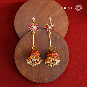 Jhumkie earring showcasing exquisite Kemp work, meticulously crafted in 92.5% silver with a fine gold polish finish. Adorned with delicate pearls, they blend classic elegance with expert craftsmanship, making them a timeless addition to any jewelry collection.