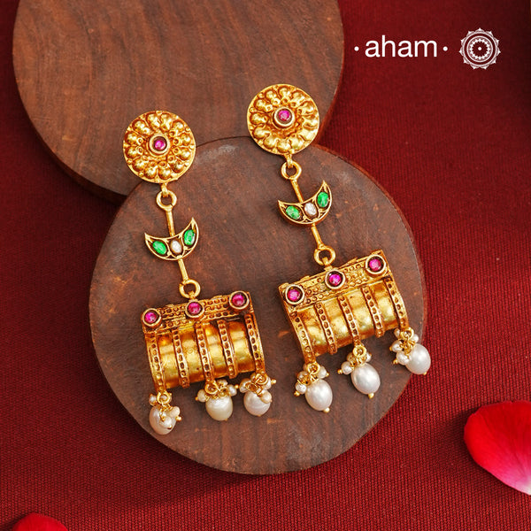 These Gold Polish Peacock Silver Earrings beautifully reflect the elegance of South Indian traditional design, featuring delicate kemp work. Crafted from 92.5% pure silver with a fine gold polish, it is a graceful and timeless design that complements your style effortlessly.