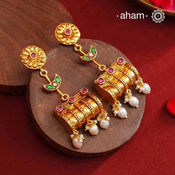 These Gold Polish Peacock Silver Earrings beautifully reflect the elegance of South Indian traditional design, featuring delicate kemp work. Crafted from 92.5% pure silver with a fine gold polish, it is a graceful and timeless design that complements your style effortlessly.