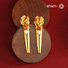 Stylish peacock earrings with coral and kundan ascents. Handcrafted using traditional methods in 92.5 sterling silver with gold polish. Pair these with your ethnic outfits this festive season to ace your look.