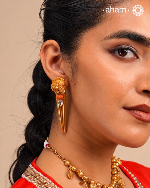Stylish peacock earrings with coral and kundan ascents. Handcrafted using traditional methods in 92.5 sterling silver with gold polish. Pair these with your ethnic outfits this festive season to ace your look.