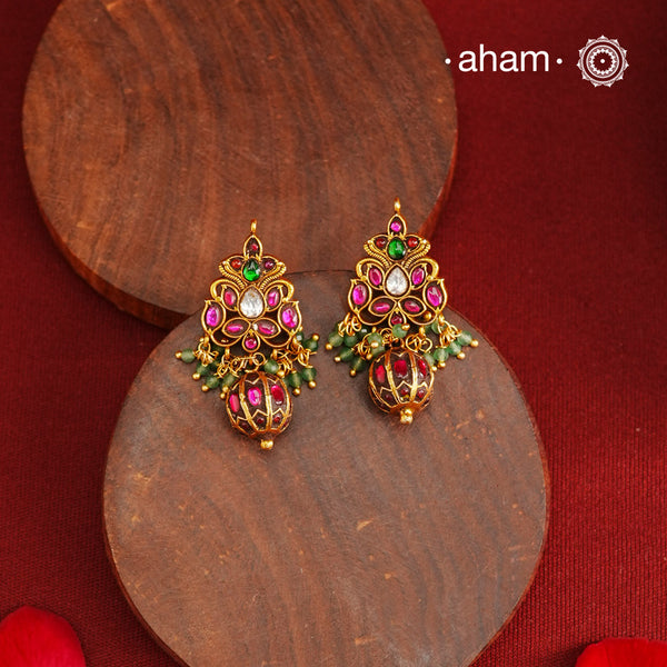 Gold polish silver earrings showcasing intricate kemp work, meticulously handcrafted in 92.5 sterling silver using traditional methods. The rich gold finish enhances their timeless appeal, making them an ideal accessory to elevate ethnic outfits during festive occasions with elegance and authenticity.