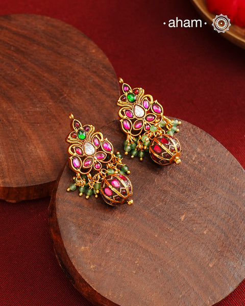 Gold polish silver earrings showcasing intricate kemp work, meticulously handcrafted in 92.5 sterling silver using traditional methods. The rich gold finish enhances their timeless appeal, making them an ideal accessory to elevate ethnic outfits during festive occasions with elegance and authenticity.