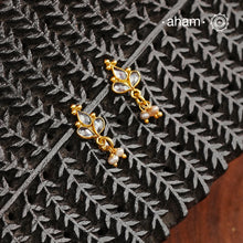Mini earrings crafted in silver and fine gold polish. The earrings are set with zircon stones and pearl drops.