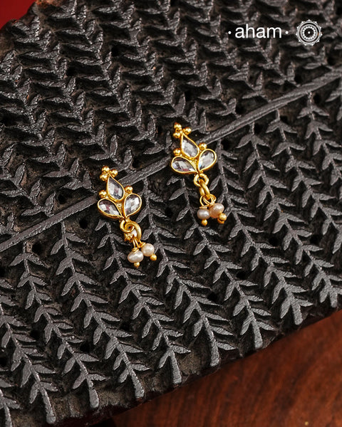 Mini earrings crafted in silver and fine gold polish. The earrings are set with zircon stones and pearl drops.