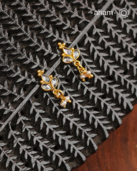 Mini earrings crafted in silver and fine gold polish. The earrings are set with zircon stones and pearl drops.