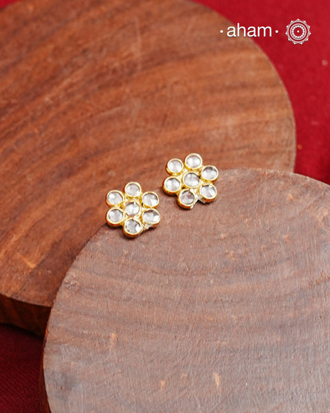 Little zircon studded earrings crafted in silver with gold polish.&nbsp;