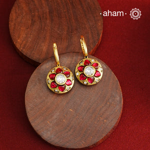 These elegant two-sided hoop earrings offer timeless style with a modern twist. Crafted from 92.5% silver and enhanced with a gold polish, they feature red kundan stones on one side and soothing feroza on the other. This unique design provides versatile wear options, allowing you to effortlessly switch between vibrant and subtle looks while enjoying the quality of fine silver craftsmanship.