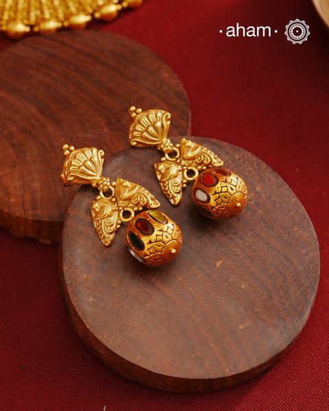 These Gold Polish Peacock Silver Earrings beautifully reflect the elegance of South Indian traditional design, featuring delicate kemp work. Crafted from 92.5% pure silver with a fine gold polish, it is a graceful and timeless design that complements your style effortlessly.