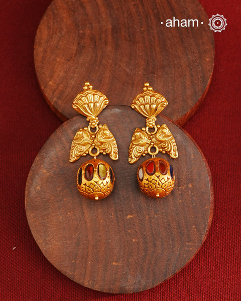 These Gold Polish Peacock Silver Earrings beautifully reflect the elegance of South Indian traditional design, featuring delicate kemp work. Crafted from 92.5% pure silver with a fine gold polish, it is a graceful and timeless design that complements your style effortlessly.