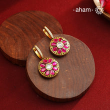 These two-sided hoop earrings combine classic elegance with contemporary design. Made from 92.5% silver and finished with a fine gold polish, they showcase red kundan stones on one side and green kundan on the other. This dual-sided feature offers versatile styling options, complementing a wide range of Indian attire. Expertly crafted, these earrings deliver both quality and adaptability for sophisticated everyday or festive wear.