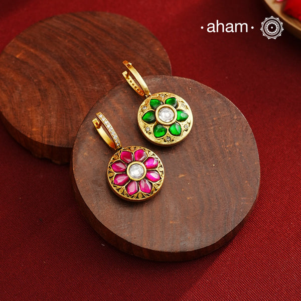 These two-sided hoop earrings combine classic elegance with contemporary design. Made from 92.5% silver and finished with a fine gold polish, they showcase red kundan stones on one side and green kundan on the other. This dual-sided feature offers versatile styling options, complementing a wide range of Indian attire. Expertly crafted, these earrings deliver both quality and adaptability for sophisticated everyday or festive wear.